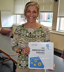 rn refresher student standing smiling for the camera with her certificate